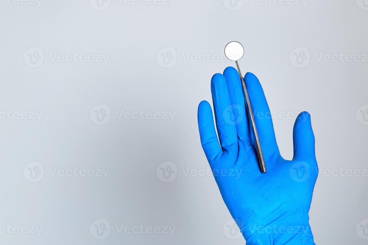 hand holding a dental tool isolated on white background. dental photo