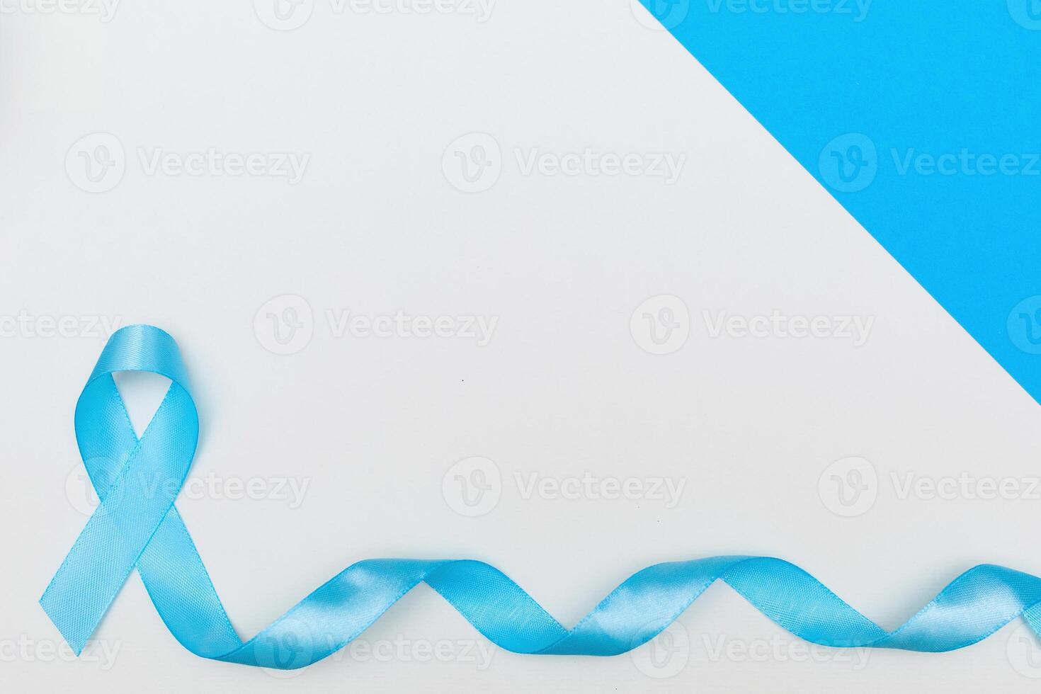 blue cancer awareness ribbon with trail on white background. concept of health and medicine photo