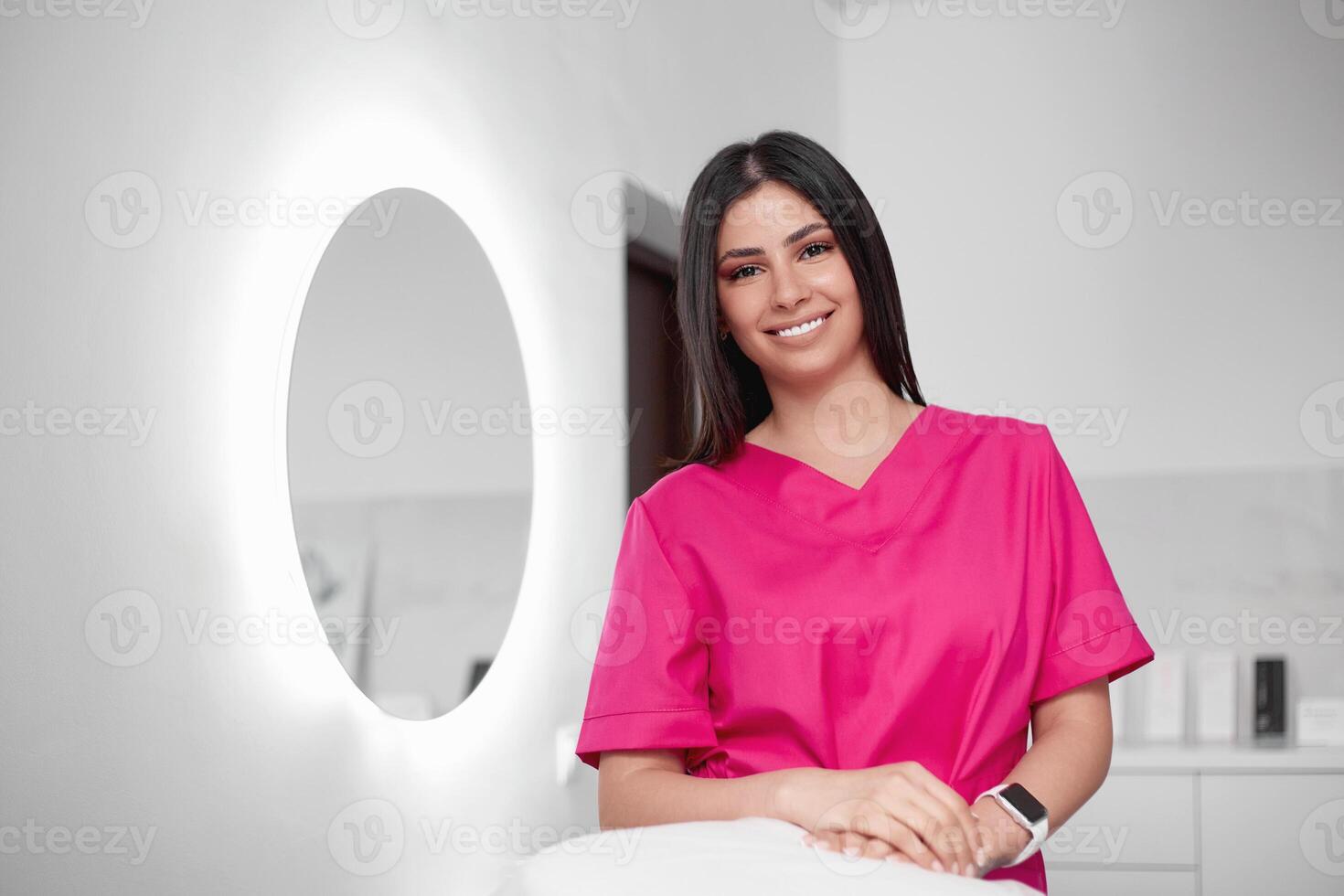 Beautiful doctor cosmetologist in a private office photo