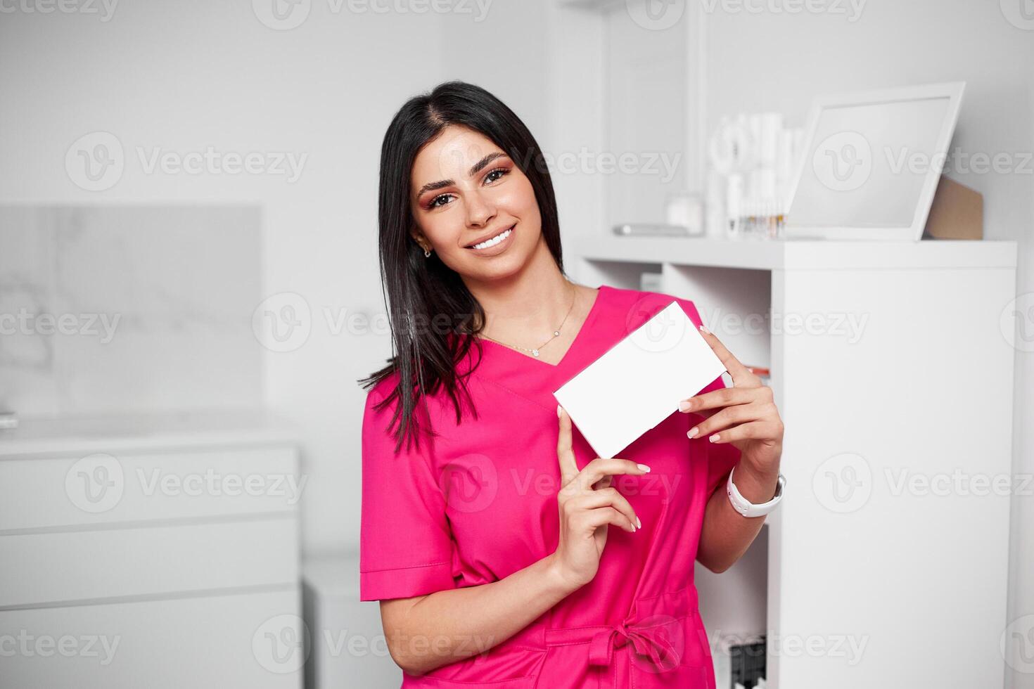 A medical cosmetologist advertises a drug for lip augmentation. Copy space on packaging. photo