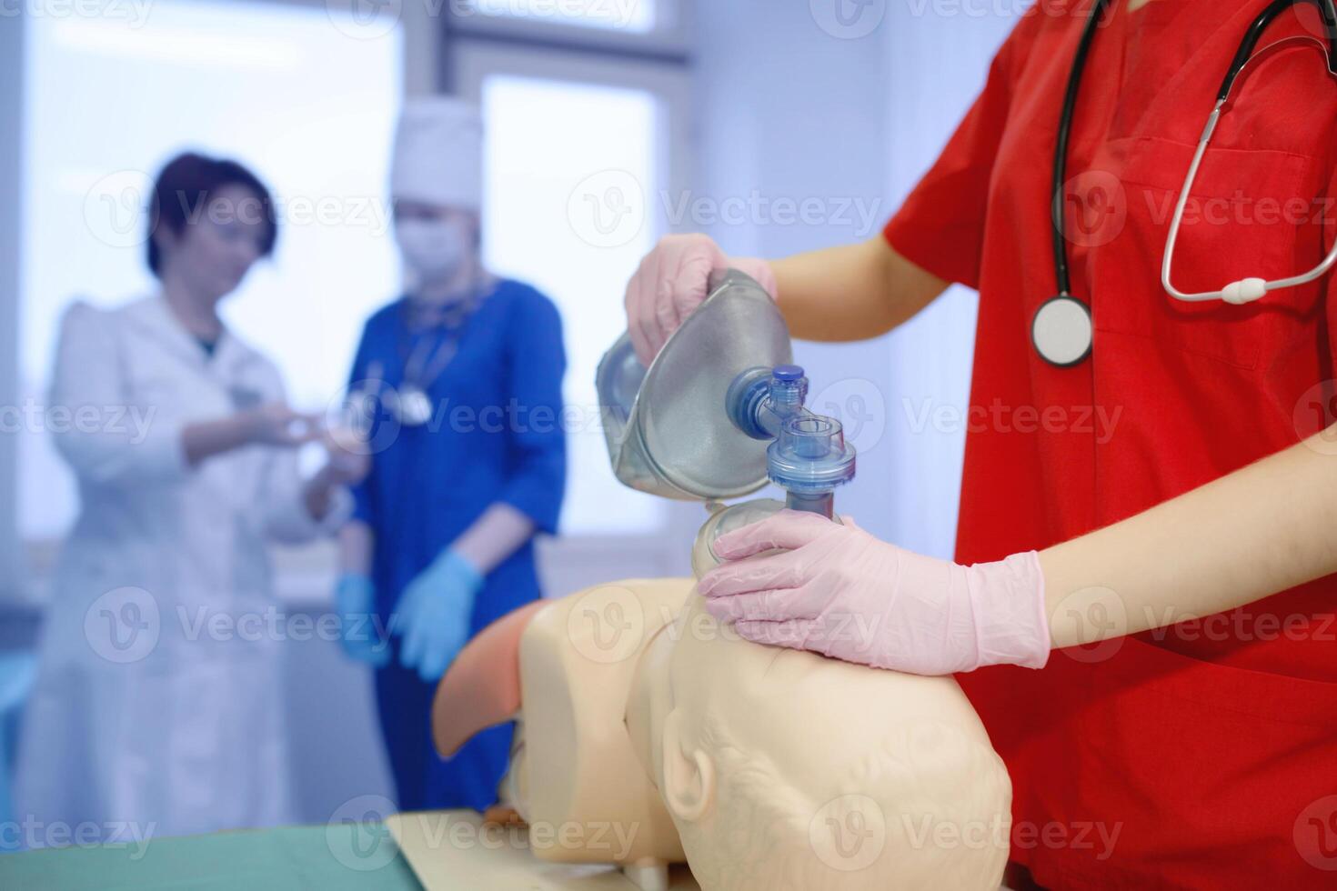 group of medical workers. The concept of the practice of artificial breathing by a young doctor. Forced oxygen delivery to the patient's lungs by a nurse. CPR background photo