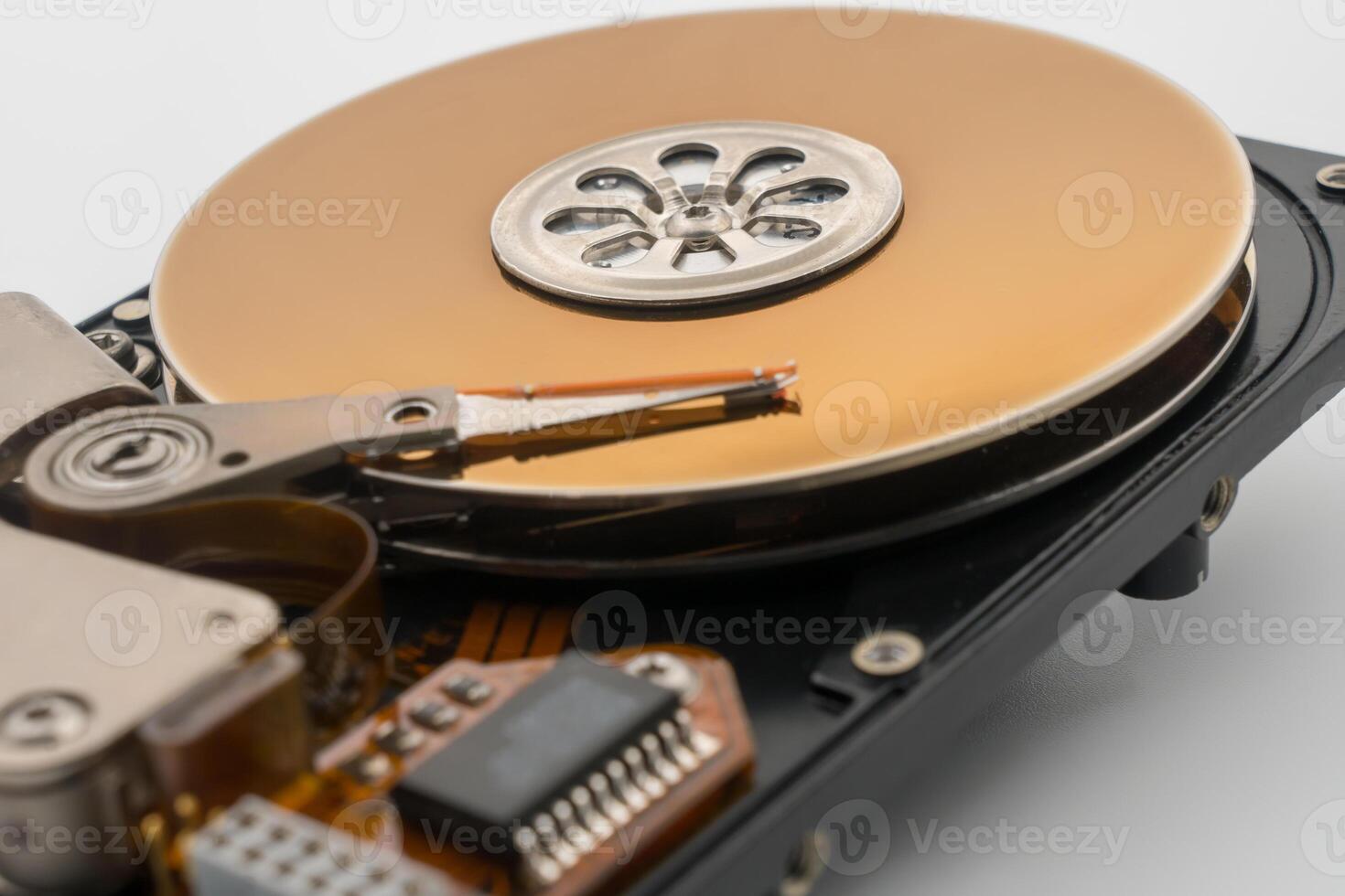 HDD, Hard disk drive, circular magnetic disk, platters. Central spindle, actuator arm with read write head. Circuit board. Mechanical and electronic components. Precision device for data storage. photo