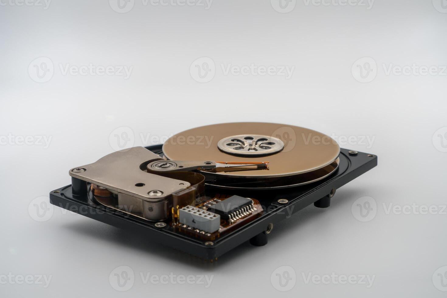 Hard disk drive , HDD, circular magnetic disk, platters. Central spindle, actuator arm with read write head, circuit board. Precision device for data storage, mechanical and electronic components photo