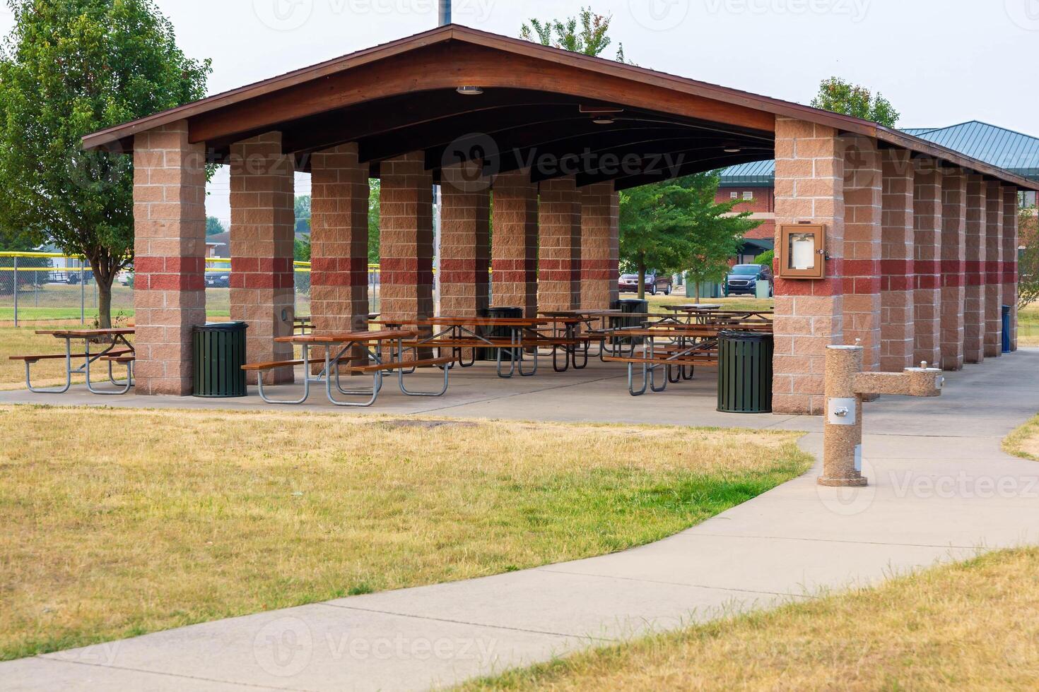 the picnic tables in a pavilion are ready for the days visitor photo