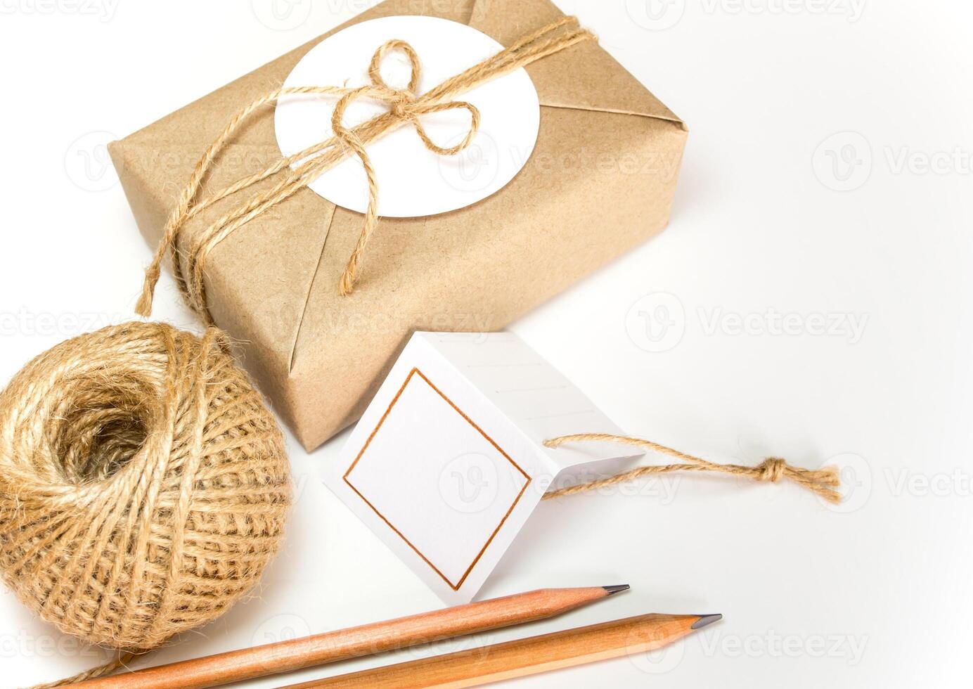 Gift box wrapped in kraft paper and rustic hemp as natural rustic style photo