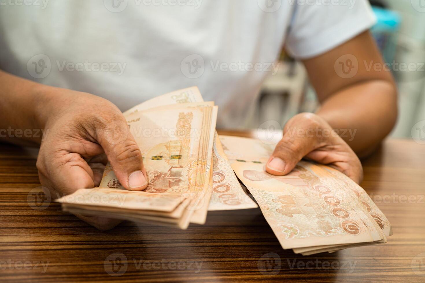Asian business woman holding Thai banknote currency money. photo