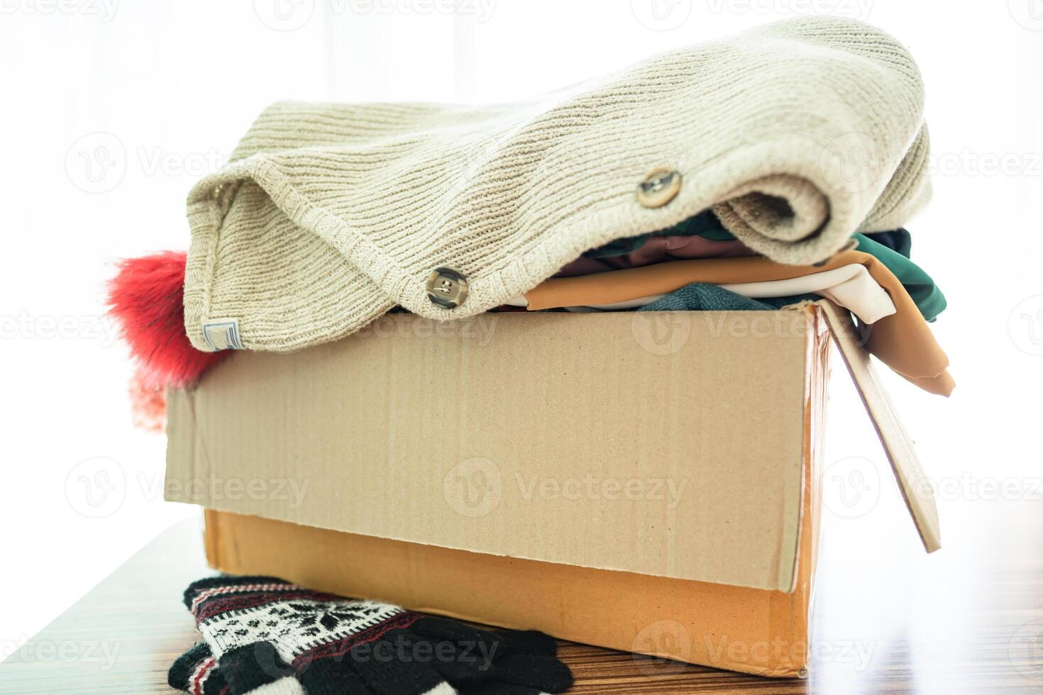 Donation box with used clothes at home to support help for poor people in the world. photo