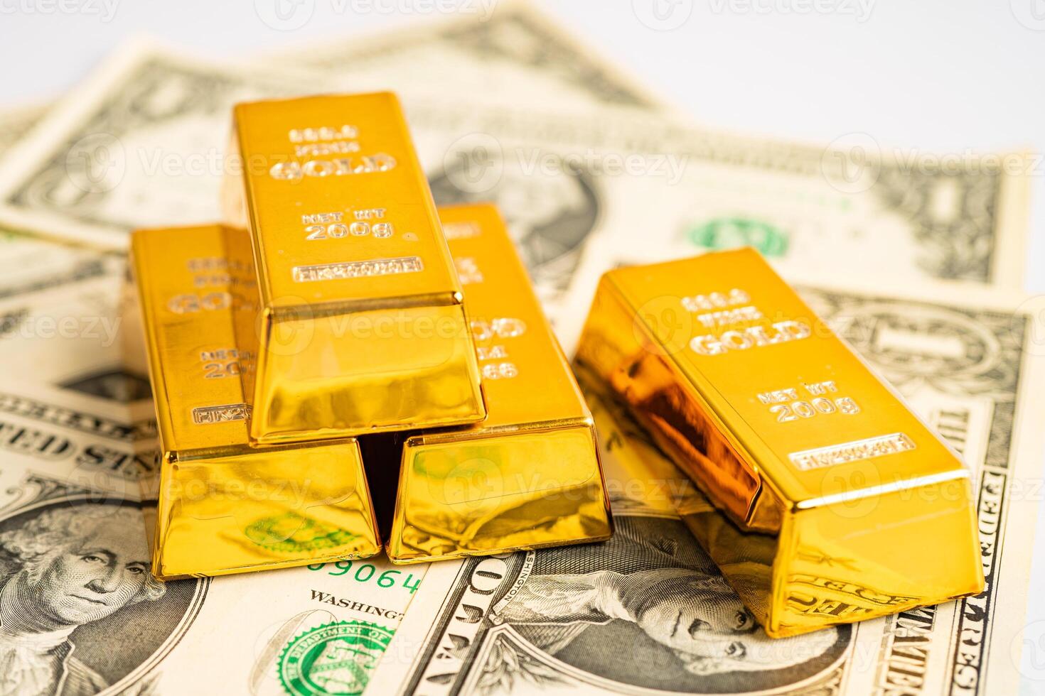 Gold bar on US dollar banknotes money and graph, economy finance exchange trade investment concept. photo