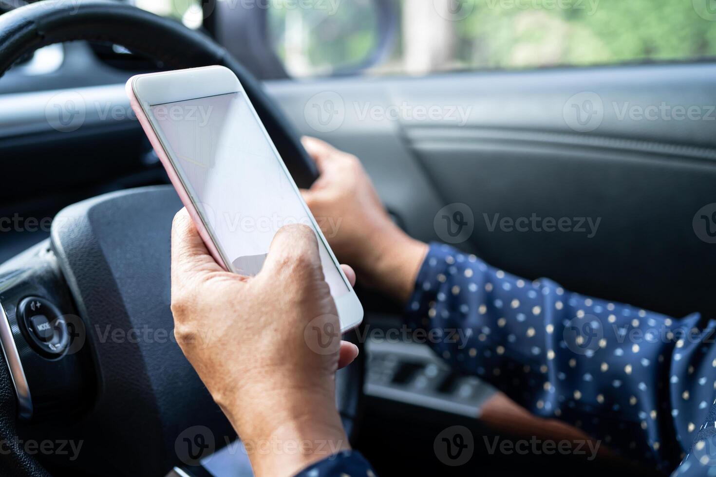 Holding mobile phone in car to communication with family and friends. photo