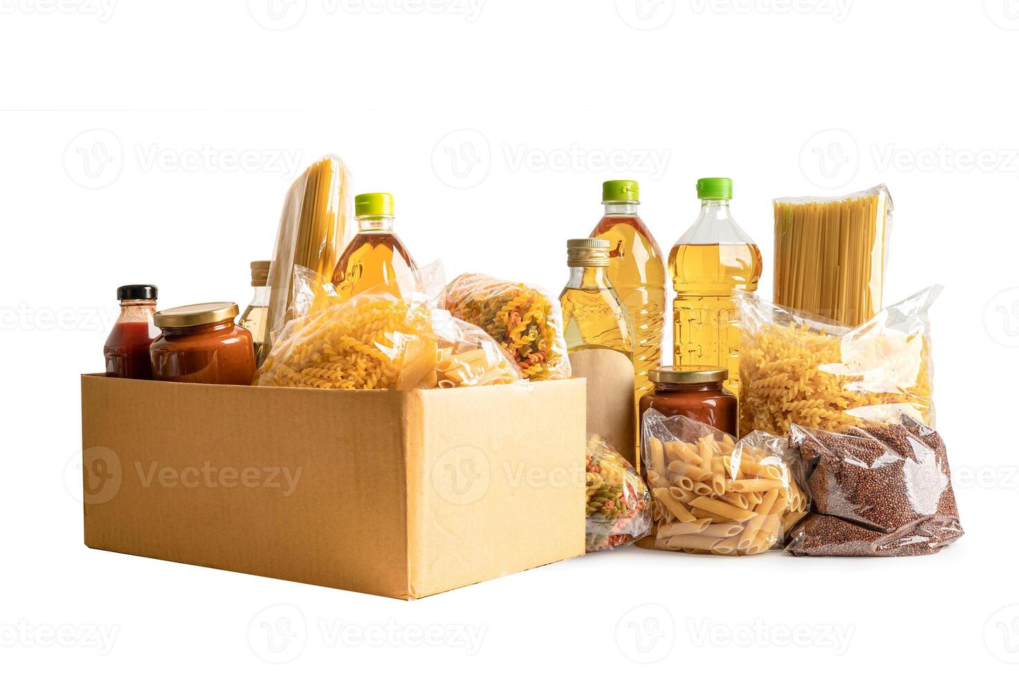 Foodstuff for donation isolated on white background with clipping path, storage and delivery. Various food, pasta, cooking oil and canned food in cardboard box. photo