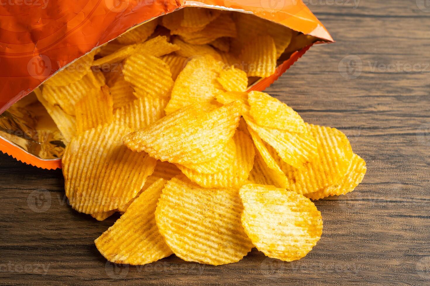 Potato chips, delicious BBQ seasoning spicy for crips, thin slice deep fried snack fast food in open bag. photo