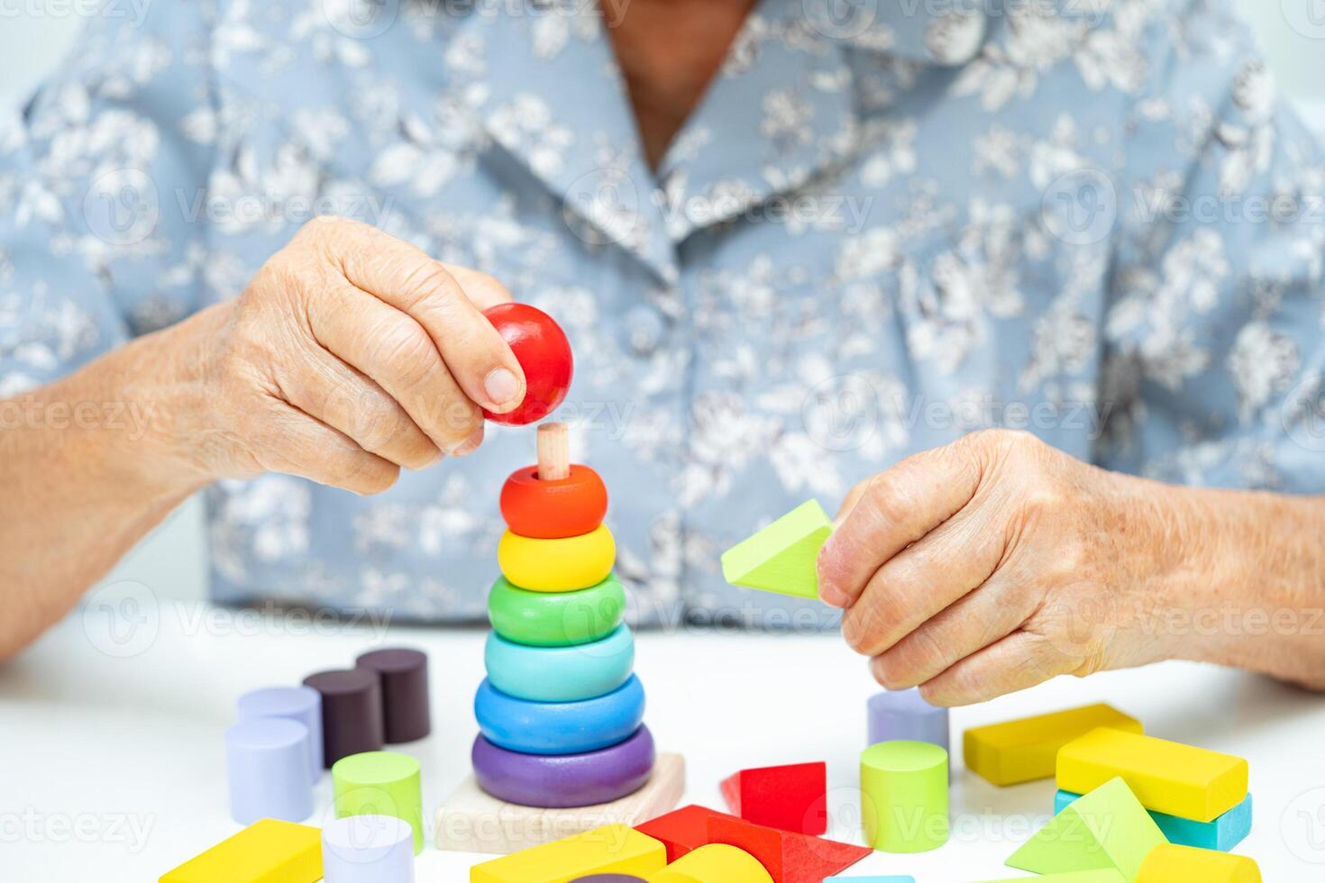 Alzheimer disease AD, Asian elderly woman patient suffering from dementia learn practical motor skills rehabilitation. photo