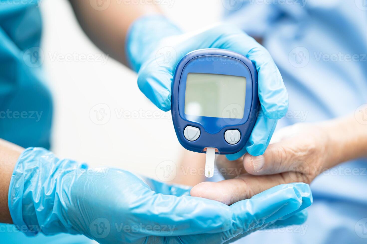 Doctor check diabetes from finger blood sugar level with finger lancet. photo