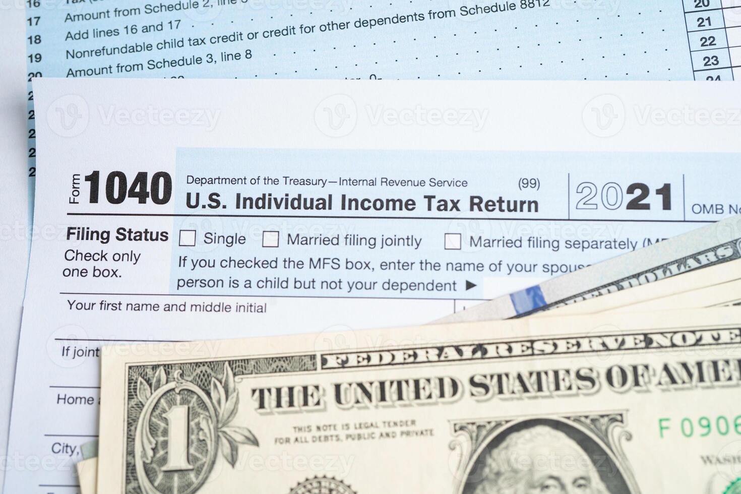 Tax Return form 1040 and dollar banknote, U.S. Individual Income. photo