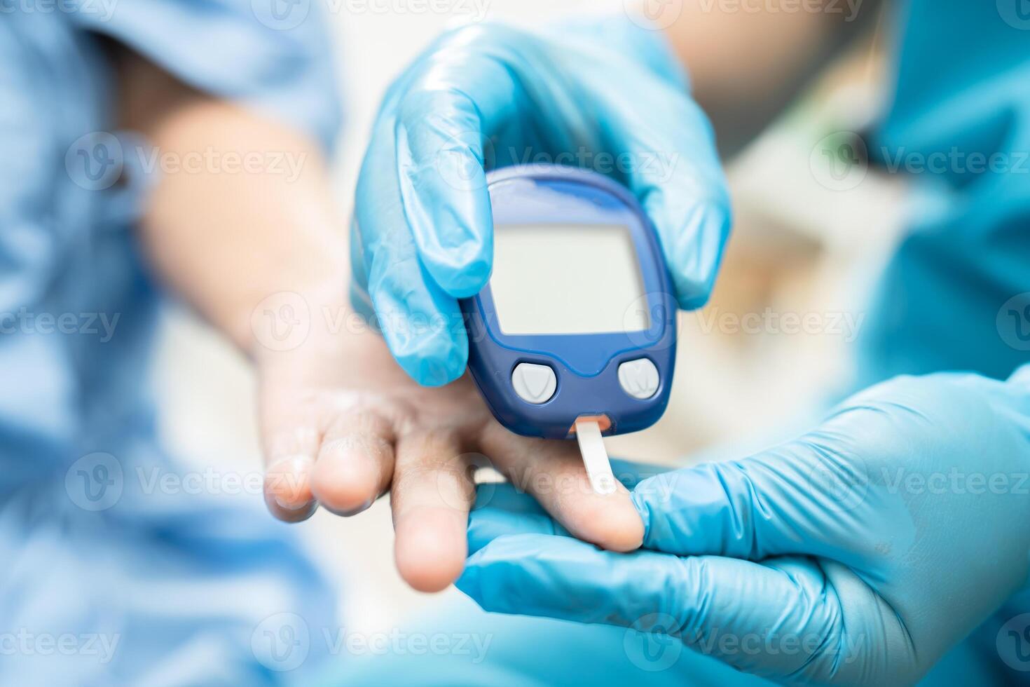 Doctor check diabetes from finger blood sugar level with finger lancet. photo