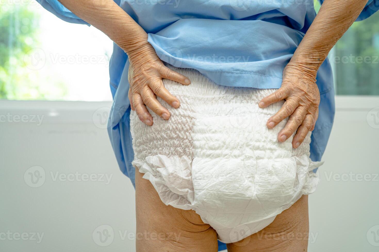 Asian senior woman patient wearing incontinence diaper in hospital, healthy strong medical concept. photo