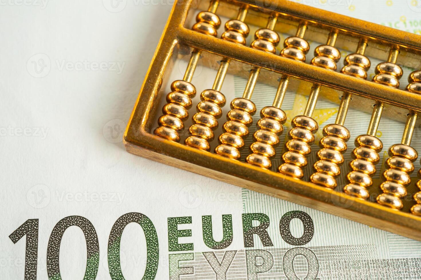 Gold abacus on Euro banknote money, economy finance exchange trade investment concept. photo