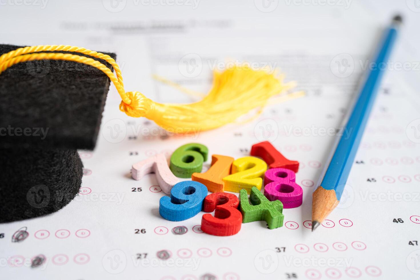 Graduation gap hat and pencil on answer sheet paper, Education study testing learning teach concept. photo