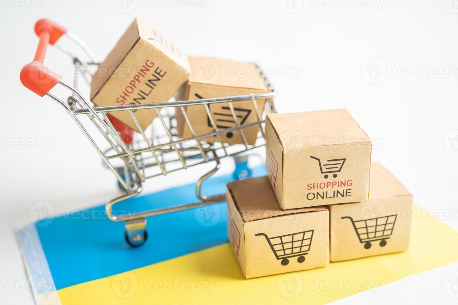 Box with shopping online cart logo and Ukraine flag, Import Export Shopping online or commerce finance delivery service store product shipping, trade, supplier concept. photo