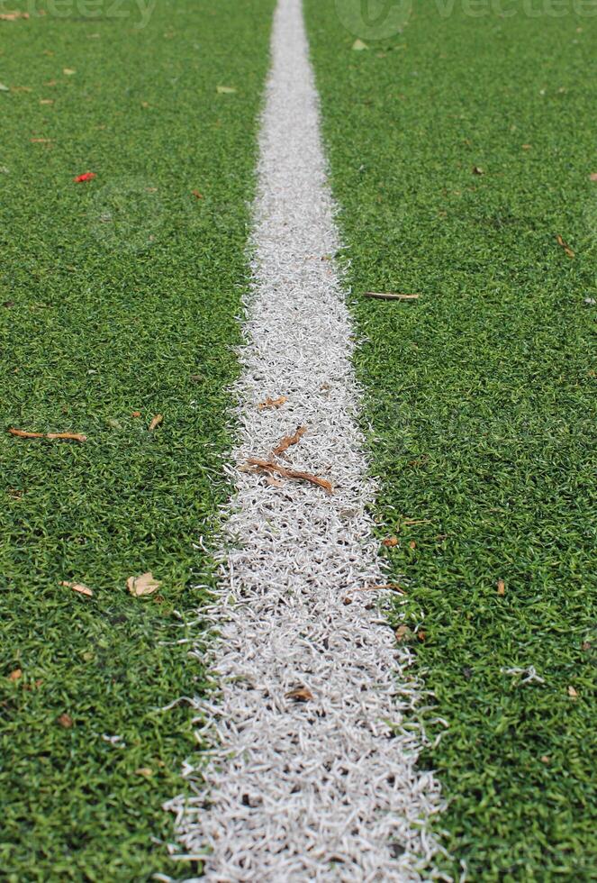 The receding distance is a straight white line on the artificial turf of the football field photo