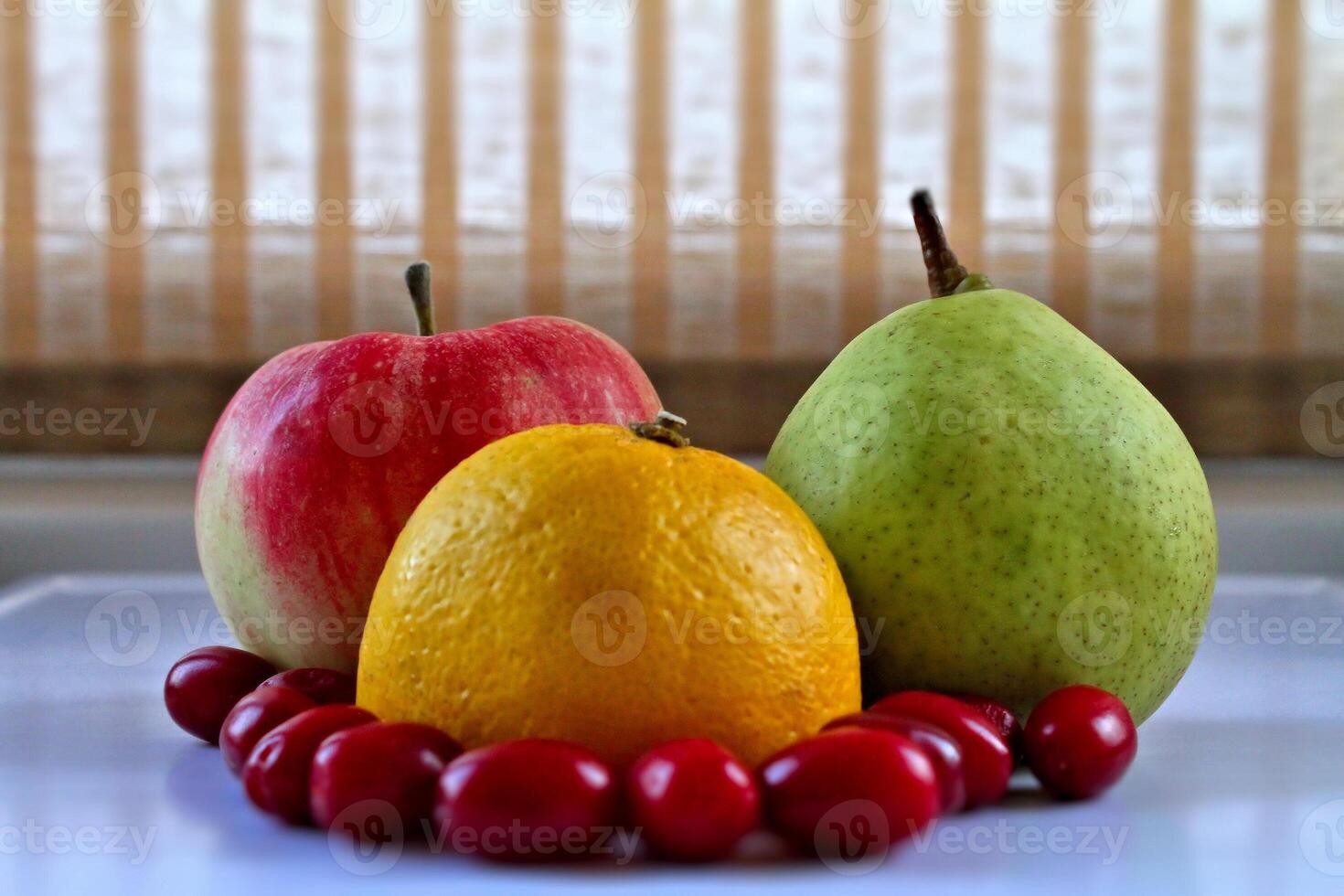 Fresh Fruits Set. Whole fruits and dogwood berries on white tray closeup stock photo