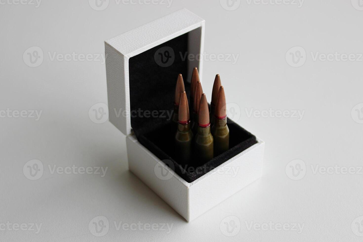 Seven Bullets Inside A Jewelry Case On Clear White Surface Metaphoric Stock Photo