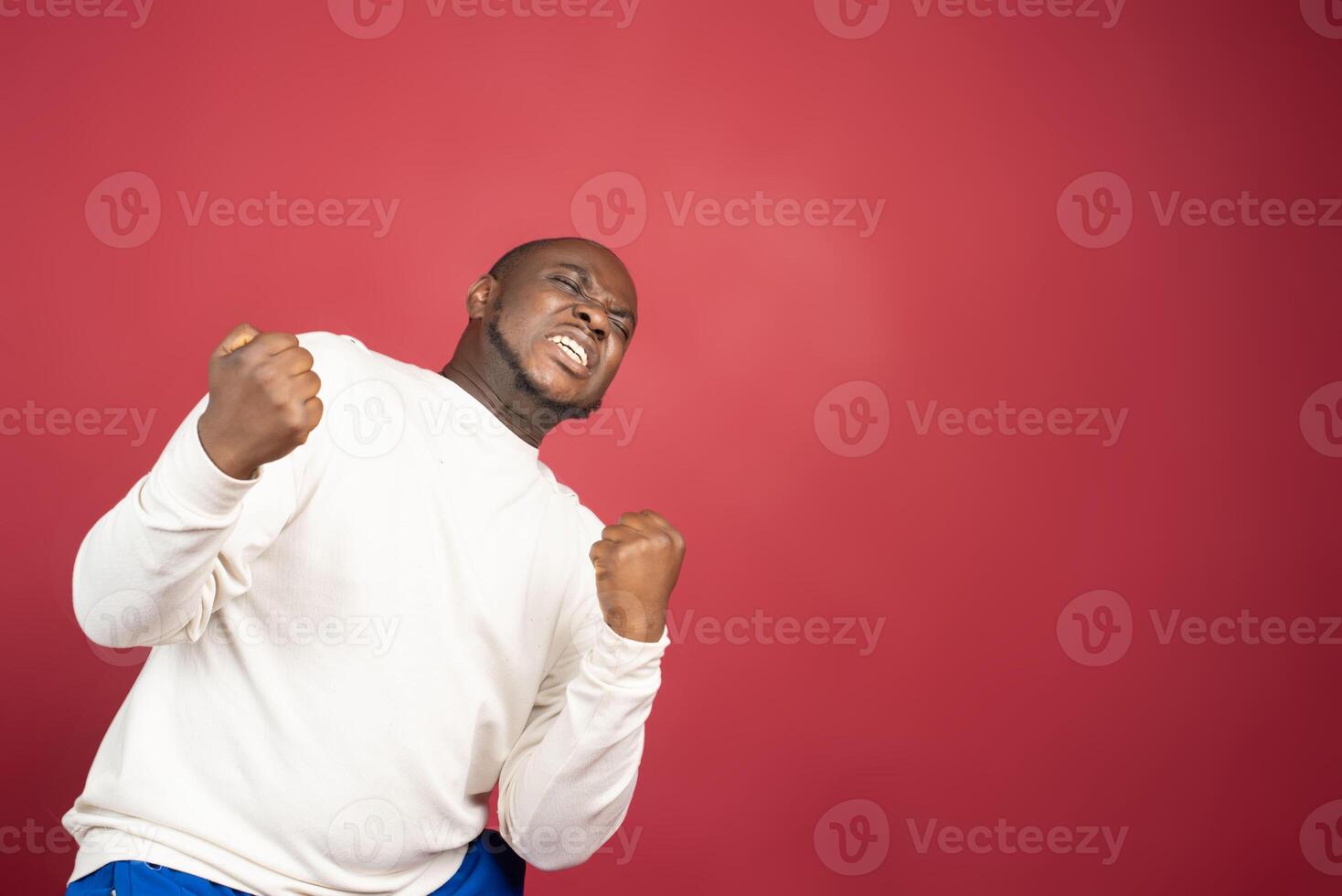 I'm winner. Portrait of happy african american man isolated over red background. photo