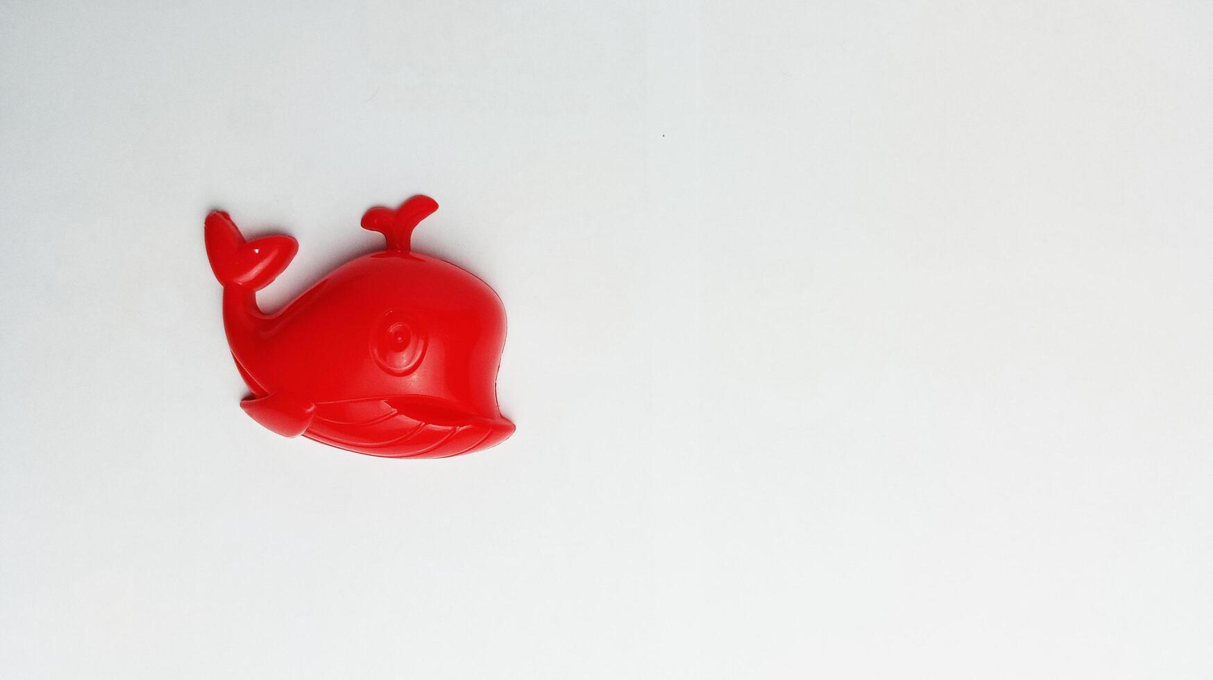 children's toy red whale on a white background photo