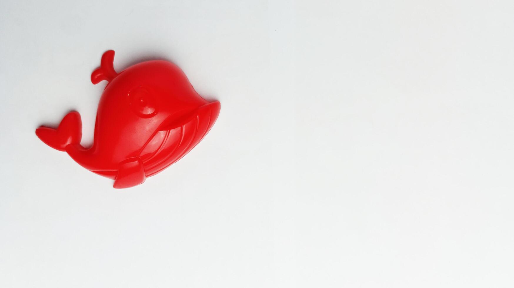 children's toy red whale on a white background photo