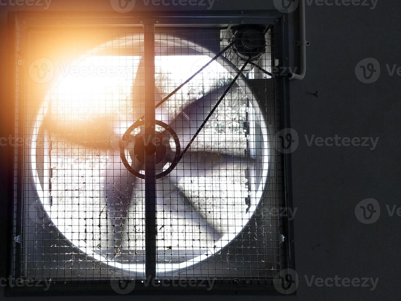 Big industrial Exhaust fan in a factory. Ventilation of plant building. With Shiny light. photo