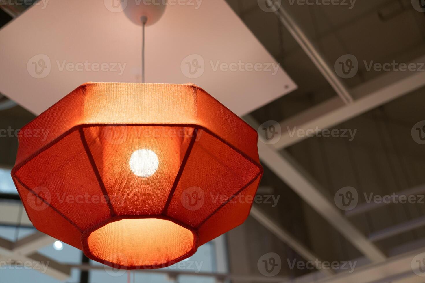 Red lamp shade. Hanging Lamp with Red Shade, Modern Chandelier with Light Bulb. photo