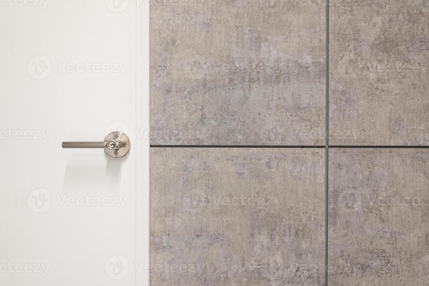 door handle on white door. metal door knob on modern interior. Shiny silver door handle. Concept of interior details. Copy space. photo