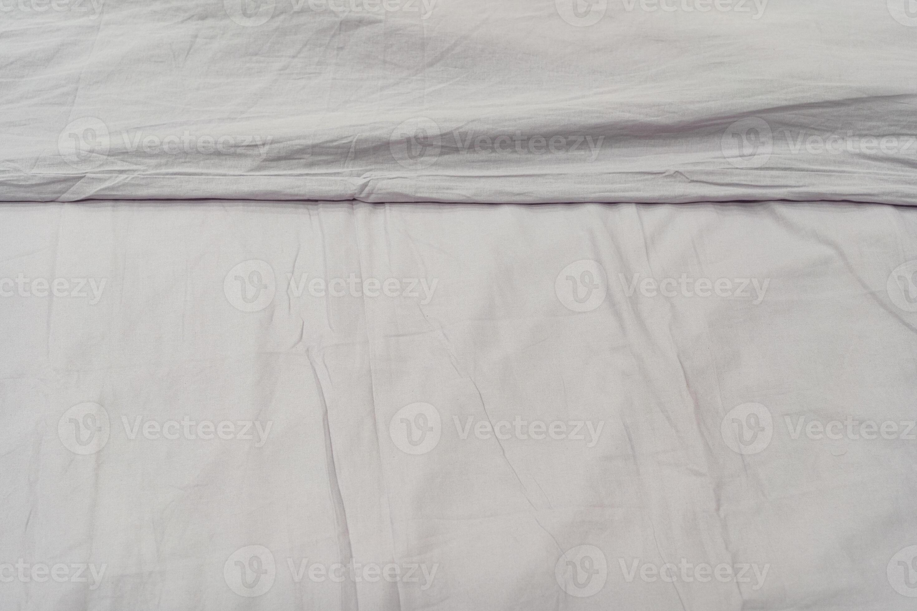 Wrinkled gray bedsheet background. Top view of cozy fabric texture