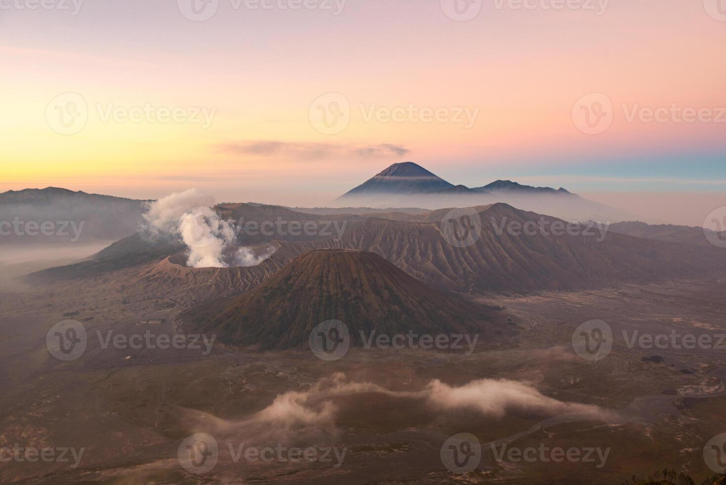 Spectacular view of Mount Bromo at dawn. This is an active volcano part of the Tengger massif, in East Java, Indonesia. Beautiful pastel sky in the morning. photo