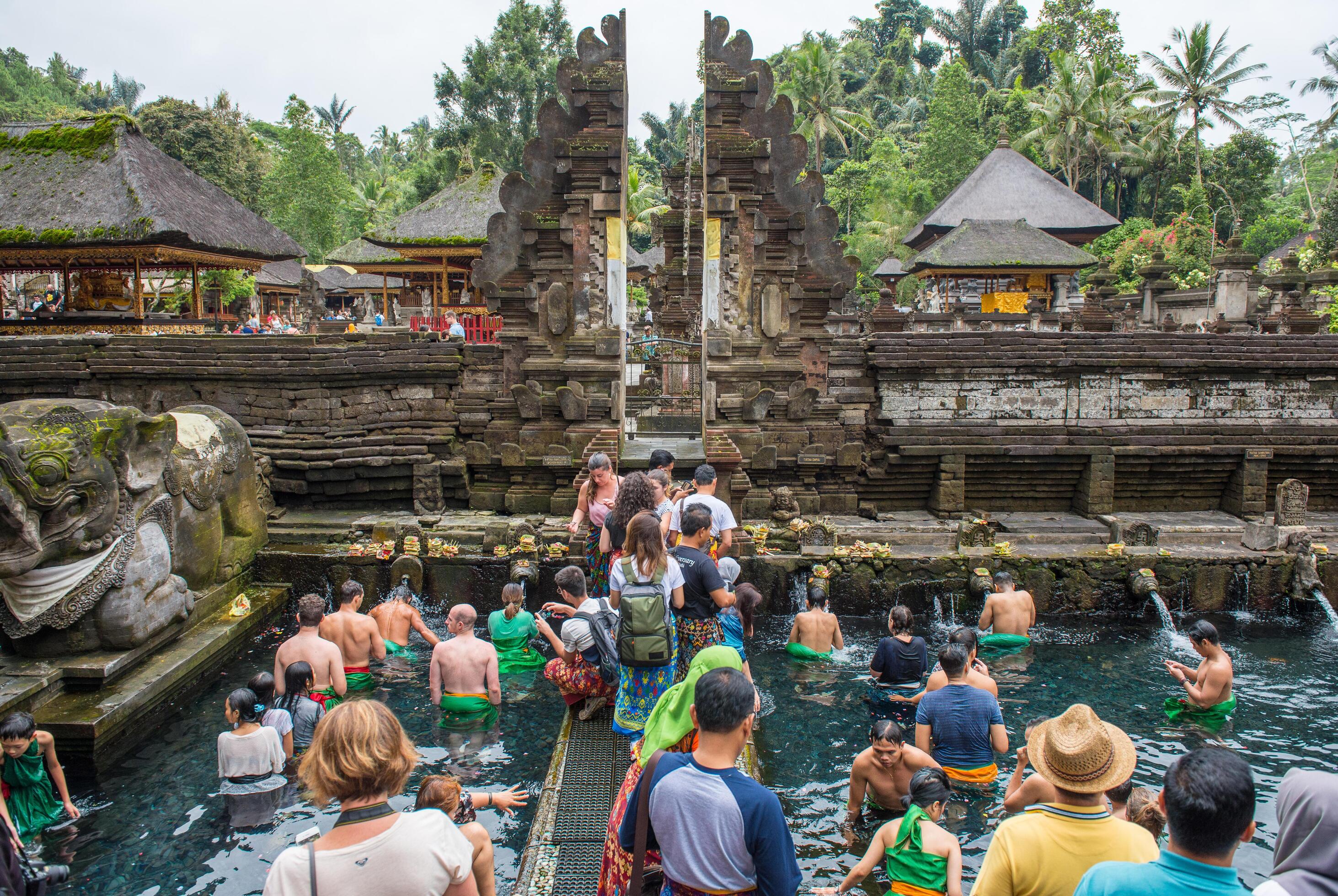 Traditional Balinese temple with tourists in background