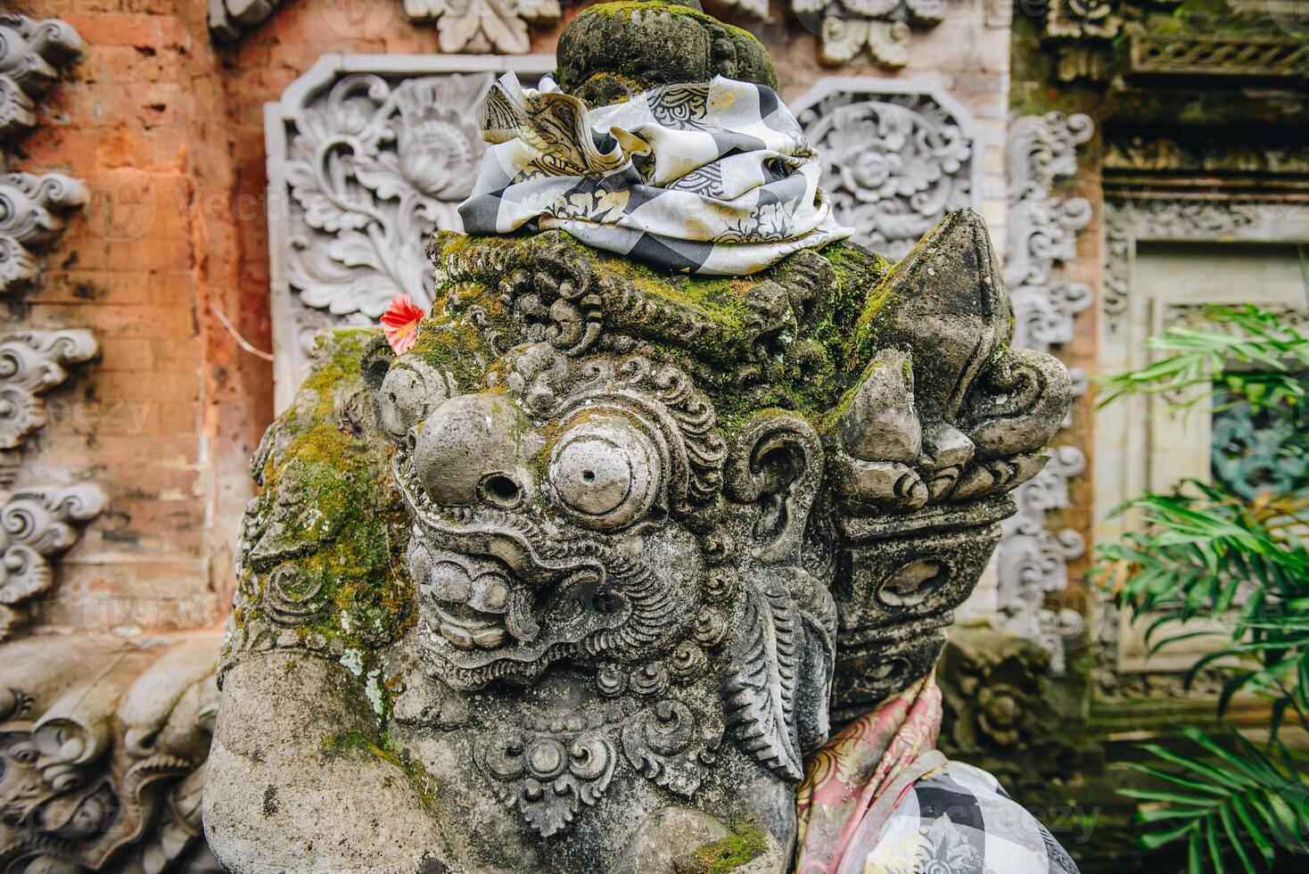 Traditional Balinese stone statue in front of Hindu temple in Ubud town of Bali, Indonesia. photo