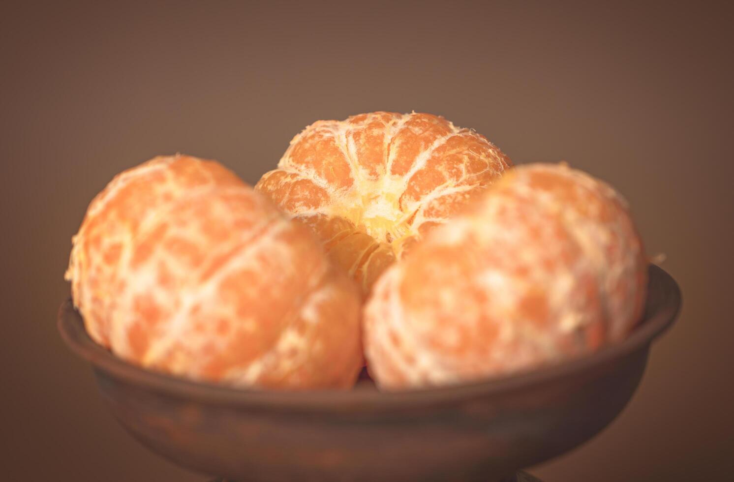 Three Tangerines in a clay plate. Vitamin-C photo