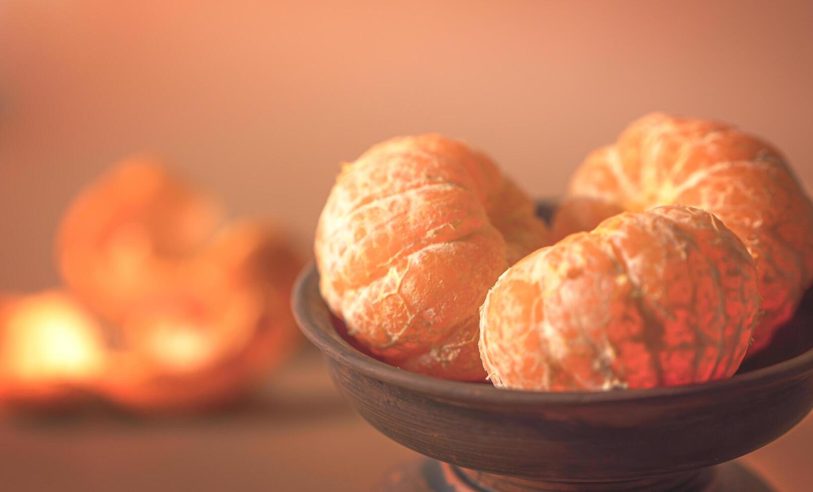 Tangerines in a clay plate and peel on the table photo