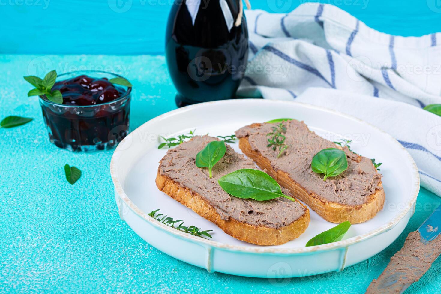 Grilled sandwich with pate with chicken liver and olives on blue background photo