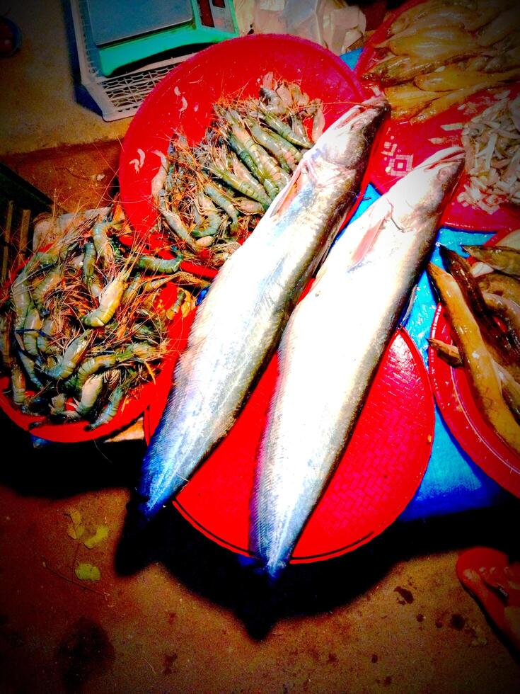 a bowl of shrimp sitting on a table photo