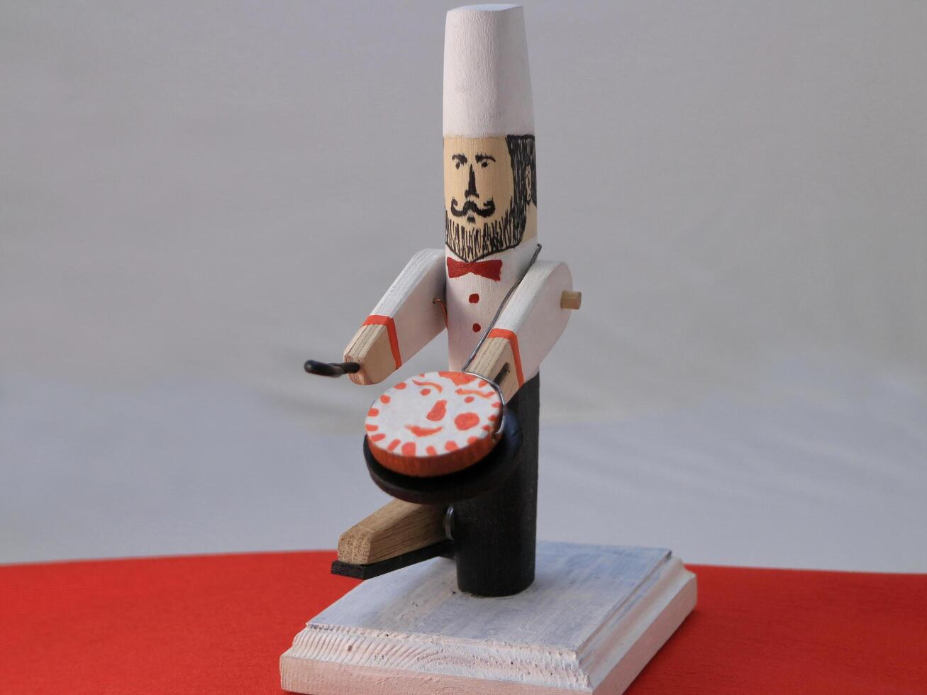 wooden toy chef with pancake in a frying pan photo