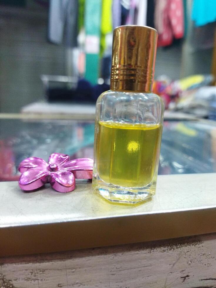 a small bottle of perfume sitting on a red cloth photo