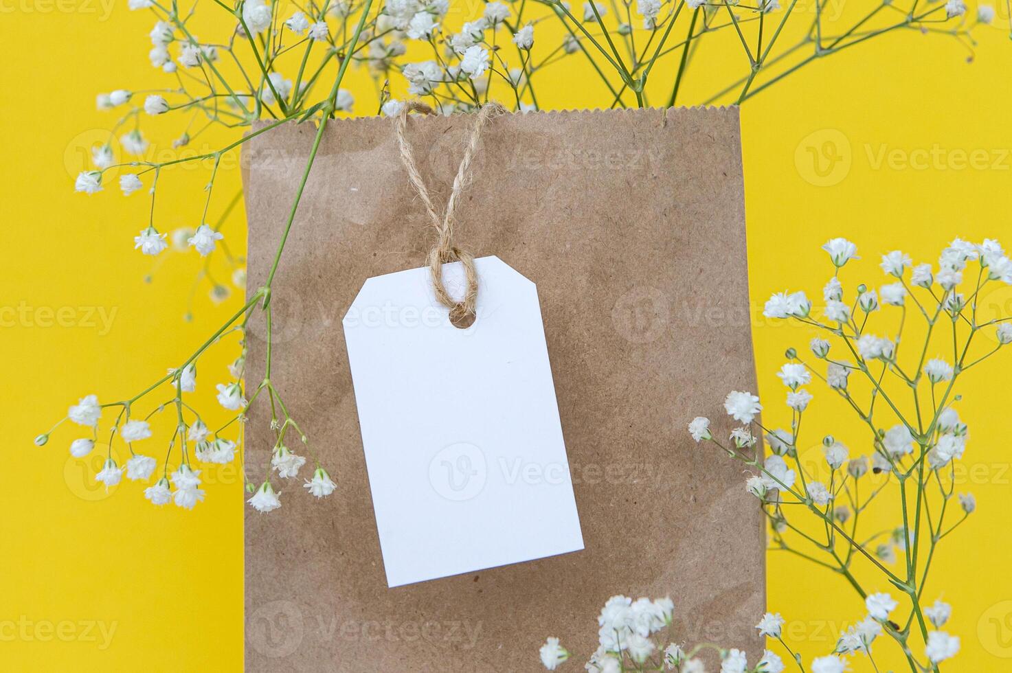 White cardboard tag for a gift box with a place for text on a white background. Side view photo