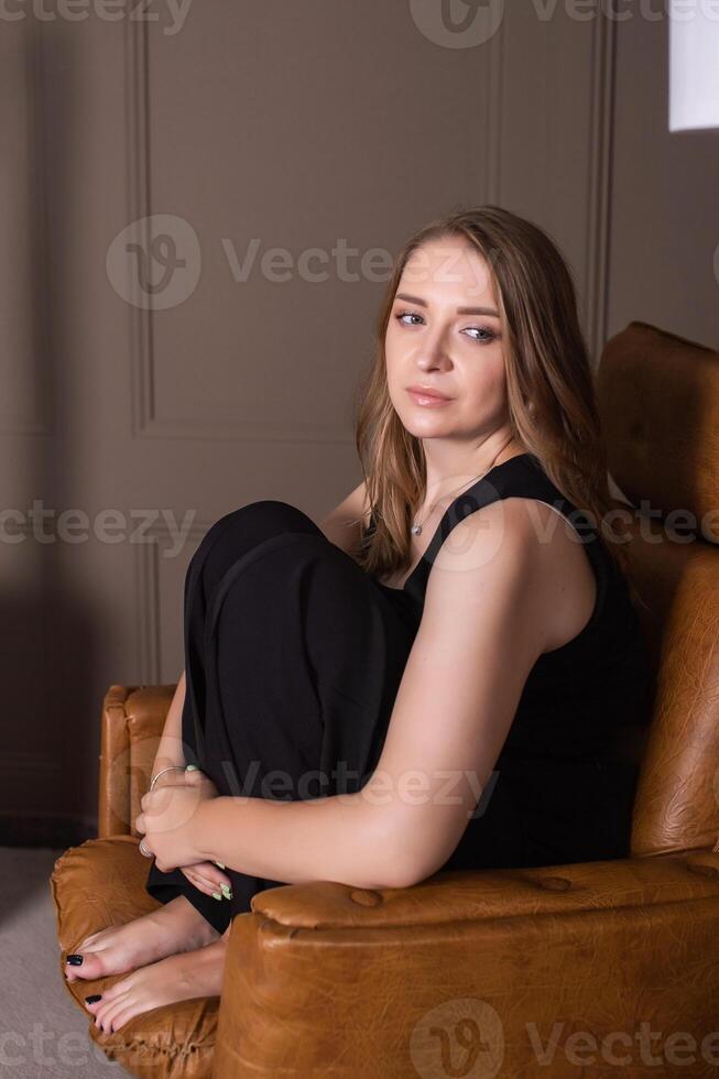 Serene Woman Relaxing in Armchair photo