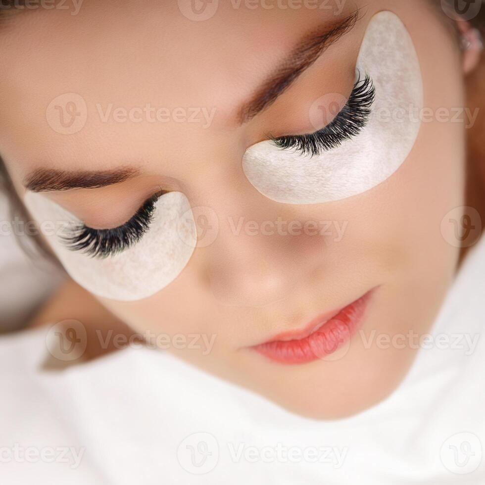Eyelash Extension Procedure. Woman Eye with Long Eyelashes. Close up, selective focus. photo