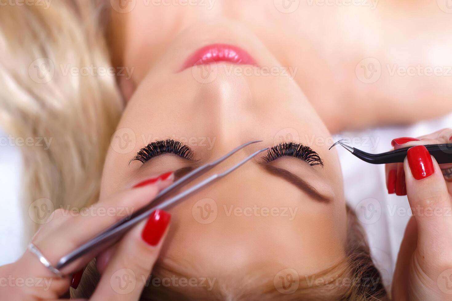 Eyelash Extension Procedure. Woman Eye with Long Eyelashes. Lashes, close up, selected focus. photo