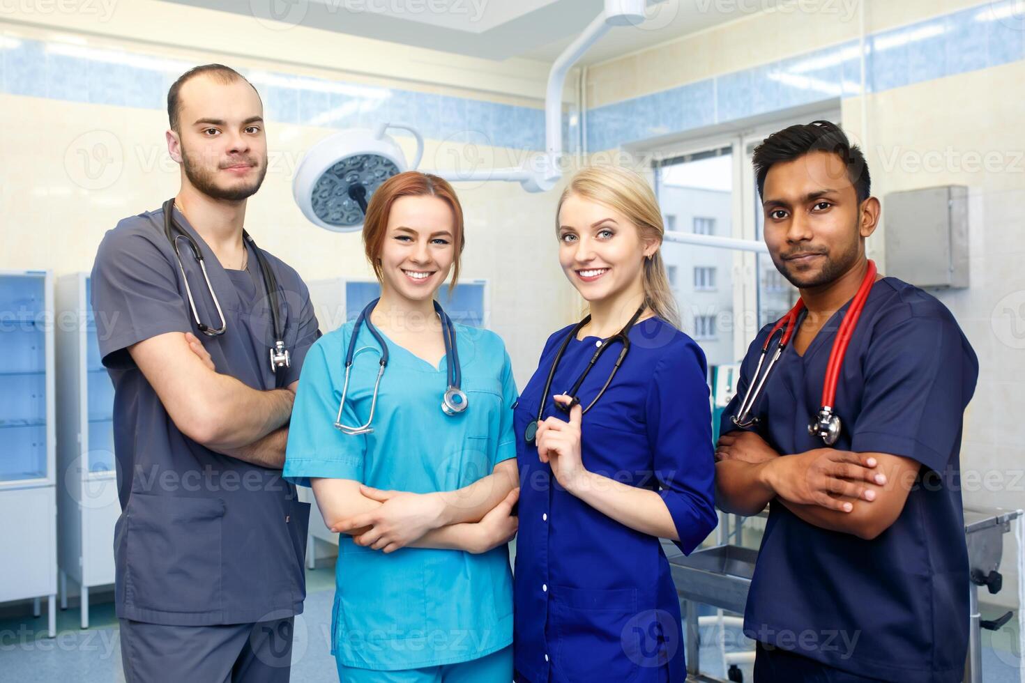 Multiracial team of young doctors in a hospital standing in a operating room photo