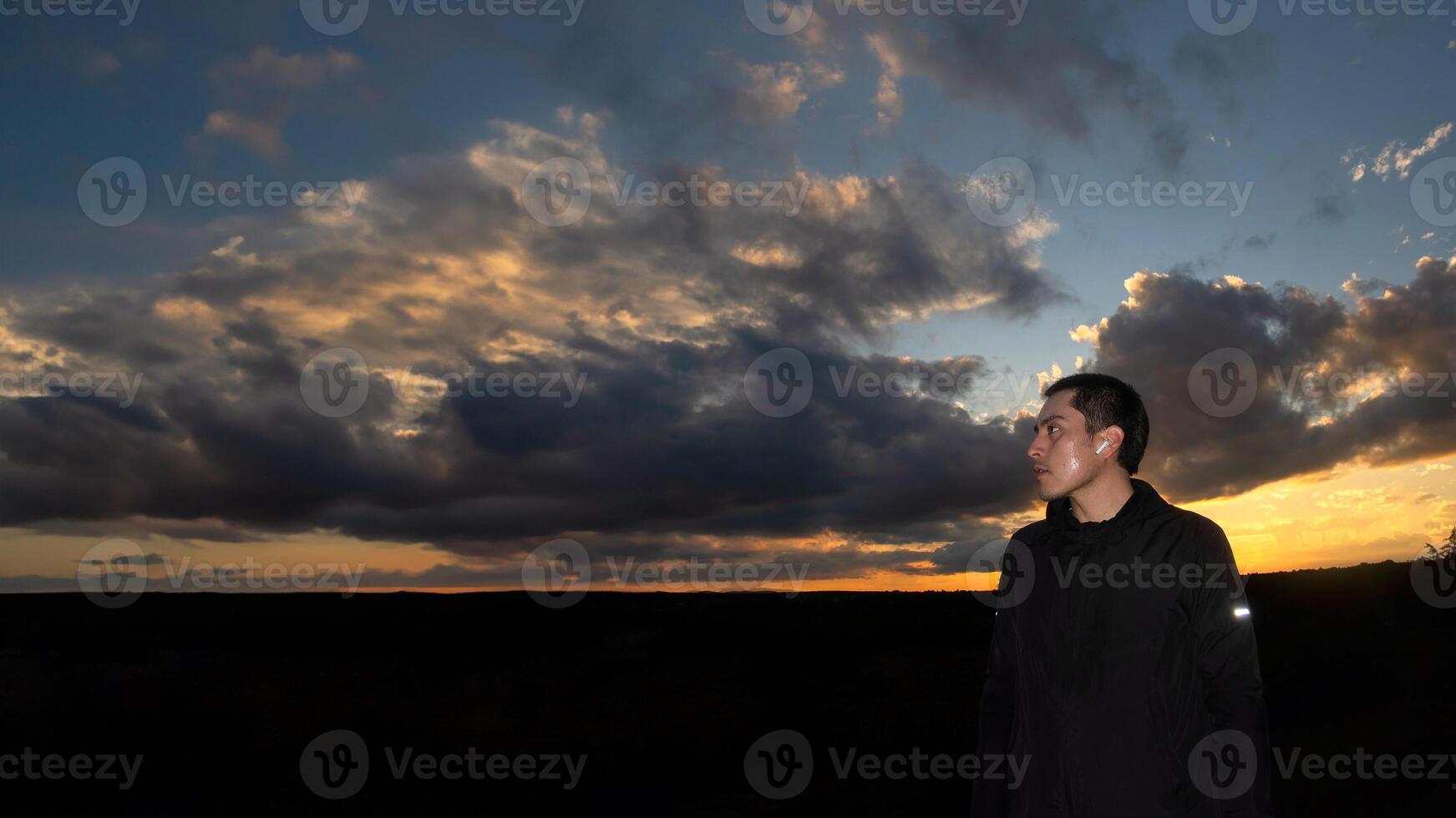 Sporty man with beautiful sunset background and space for text photo