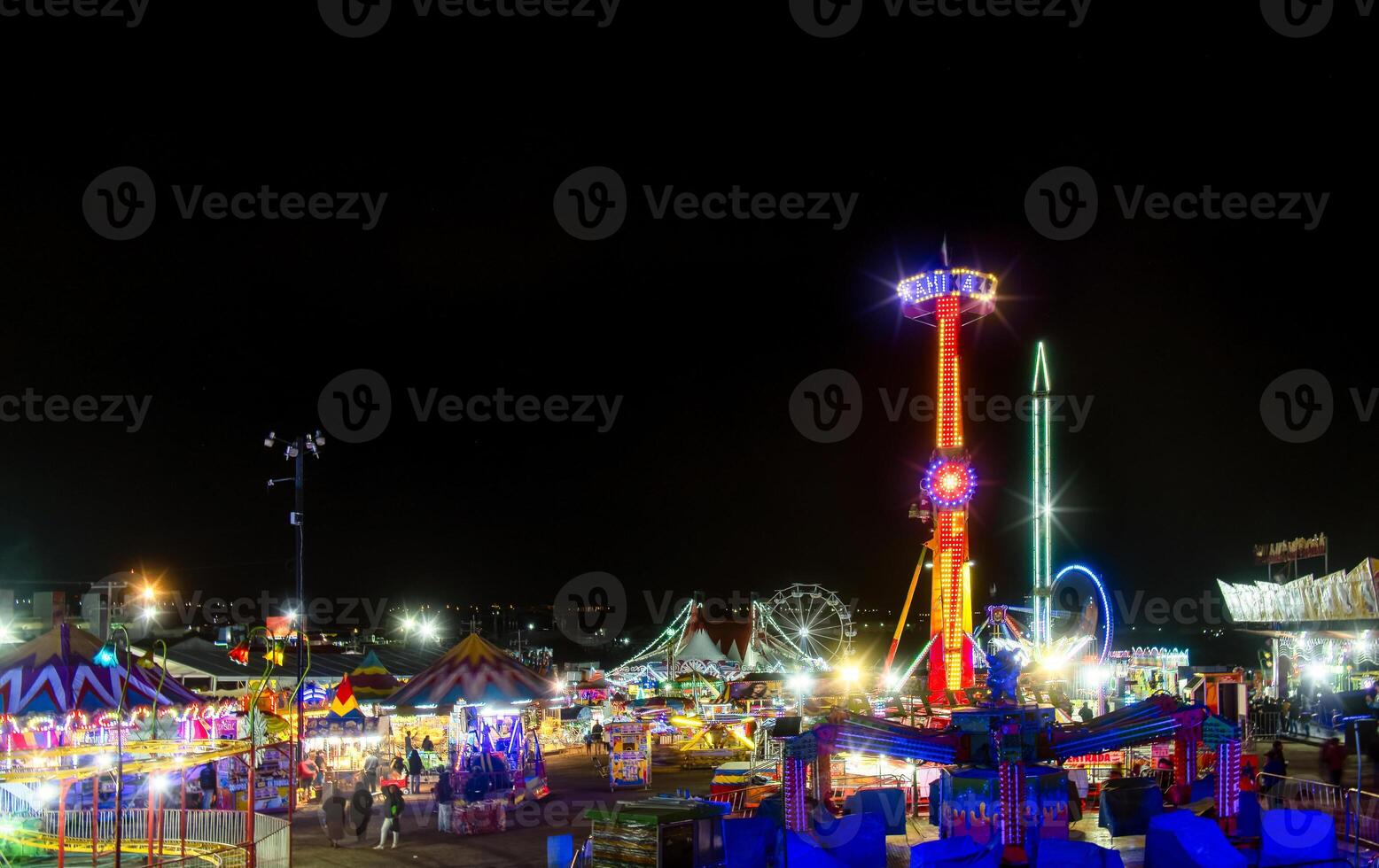 Mexican fair with rides and lights at night, with space for text photo