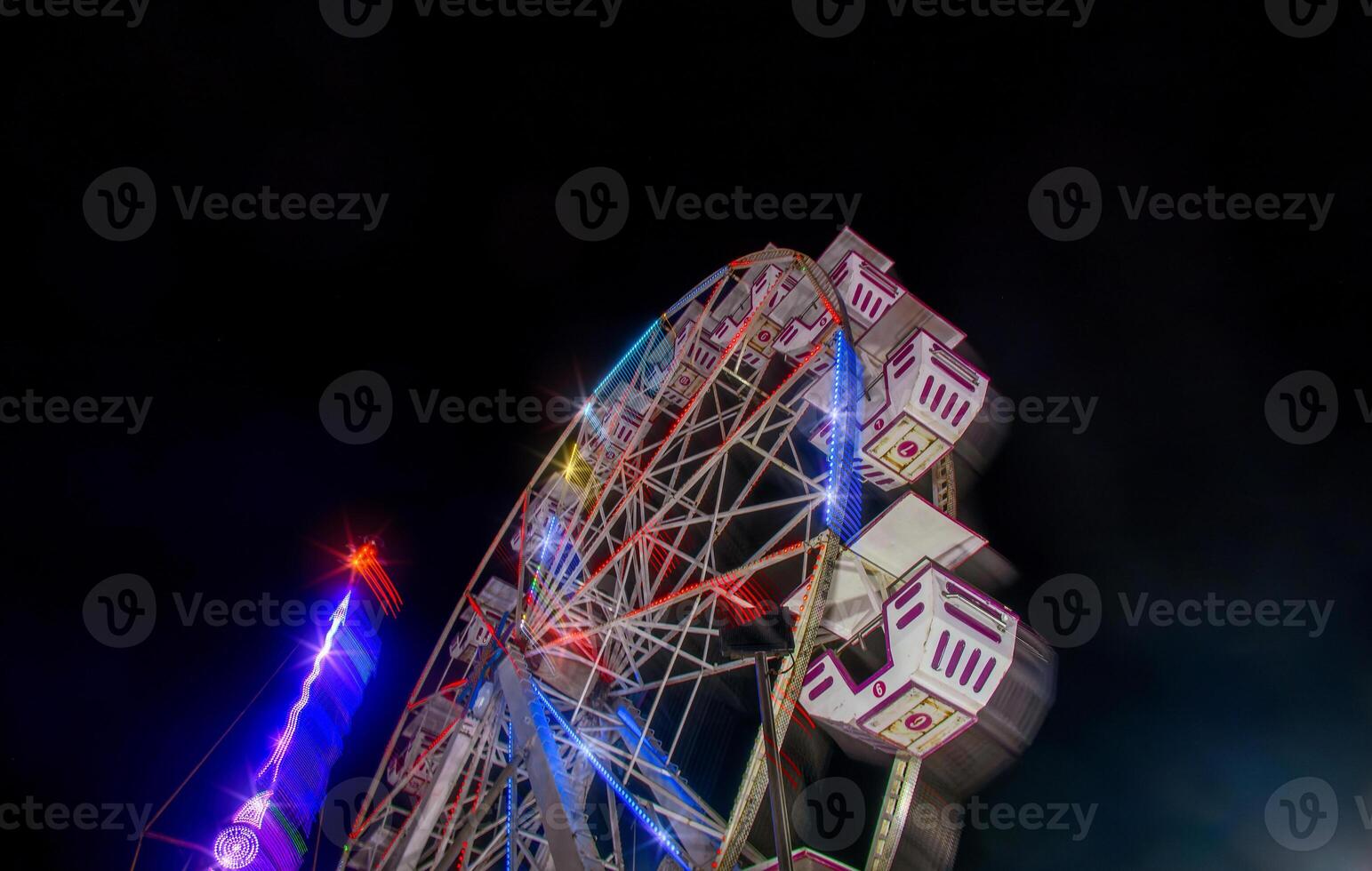 Mexican fair with rides and lights at night, with space for text photo